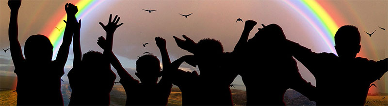 Silhouette of children with rainbow in background.
